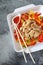 Asian food: fried chicken with tricolor bell peppers and piquant