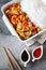 Asian food: fried chicken with tricolor bell peppers and rice vermicelli