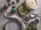 Asian food on grey concrete: shiitake mushrooms, steaming basket, hoisin sauce, coriander and spicy dip, empty plate and