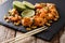 Asian food: sauteed shrimp with peanuts, lime and herb closeup.