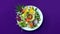 Asian food on the white plate on the purple background