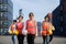 Asian foreman walking with four workers employee team after finishing work on the container depot terminal