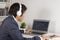 Asian Forex Trader or Investor Wear Headphone and Trading Forex or Stock by Laptop
