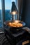 Asian fried eggrolls dish being cooked on the stove under a light near the window