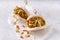 Asian fusion vegan white soft bao with okra, spicy coconut flakes, mayo and spring onion