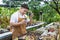 Asian gardener is working inside the greenhouse full of cactus plants collection while propagating by flower pollination for seed