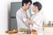 Asian gay couple homosexual cooking together in the kitchen prepare fresh vegetable make organic salad healthy food. Asian people