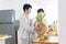 Asian gay couple homosexual cooking together in the kitchen prepare fresh vegetable make organic salad healthy food. Asian people