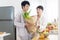 Asian gay couple homosexual cooking together in the kitchen prepare fresh vegetable make organic salad healthy food. Asian people
