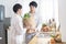 Asian gay couple homosexual cooking together in the kitchen prepare fresh vegetable make organic salad healthy food. Asian people