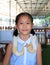 Asian girl child with pet snake or royal albino python (Boa constrictor snake)