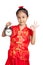 Asian girl in chinese cheongsam dress show OK sign with a clock