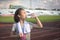 Asian girl drinking water from plastic bottles after jogging, little girl drink thirsty water due to hot weather after run in the