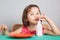 Asian girl eating a donut with milk