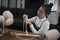 Asian girl enjoying macrame handcraft hobby - young happy and pretty Korean woman at home doing macramÃ© using ropes and cords and