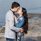 Asian girl and european guy kissing on concrete pier