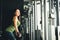 Asian girl exercising at gym, training on pushdown cable machine, with copy space. Healthy lifestyle, sporty athletic woman