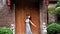 Asian girl in front of the ancient wooden door