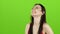 Asian girl is having fun and laughing loudly at her beautiful smile. Green screenc