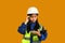 Asian girl holding helmet isolated on yellow background, future dream job career as engineer and architect