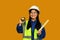 Asian girl holding helmet isolated on yellow background, future dream job career as engineer and architect