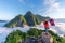 Asian girl holding Laos flag on top of Viewpoint of Nong Khiaw - a secret village in Laos.