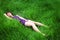 Asian girl lying on grass