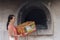 Asian girl offering Spirit money as a gift to the departed during Qing Ming festival