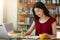 Asian girl personal assistant taking notes to notepad while working in cafe