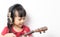 Asian girl is playing Music guitar with headphone on white background