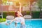 Asian girl relax stretching arm happy to enjoy at swimming pool happy enjoy relax lifestyle in public space in modern condominium
