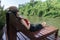 Asian girl in the resort in red clothes and hat sleep on bed pool., background