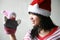 Asian girl with santa hat holding a puppet