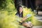 asian girl and school book in hand toothy smiling face with happiness emotion in green park