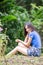 Asian girl sit down path in Bamboo forest