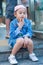 Asian girl is sitting down on granite stair