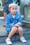 Asian girl is sitting down on granite stair