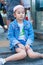 Asian girl is sitting down on granite stair