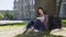 Asian girl sitting under tree, writing fast in notebook, inspiration, poetry