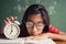 Asian girl is sleeping at the desk in the classroom, The little girl wearing glasses clutches after falling asleep in class