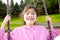 Asian girl smiling on a swing at the park