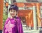 An Asian girl standing under Tori Entrance of Sumiyoshi Shrine.