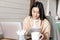 Asian girl student doing homework. Young woman taking notes while attend online webinar, working on laptop from home