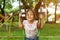 Asian girl on a swing smiling