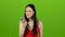 Asian girl talking on the phone, swearing, angry. Green screen