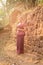 Asian Girl in Traditional Dress by an Ancient Temple Wall in Angkor, Cambodia