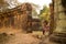 Asian Girl in Traditional Dress by an Ancient Temple Wall in Angkor Thom