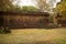 Asian Girl in Traditional Dress by an Ancient Temple Wall in Angkor Thom