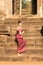 Asian Girl in Traditional Dress Climbing Stone Stairs Temple