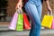 Asian girls holding sale shopping bags. consumerism lifestyle concept in the shopping mall. lady tourist walk shopping center with